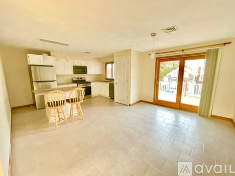 A kitchen with a dining table and chairs is available for rent.