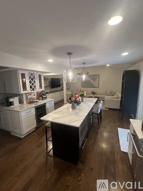 A kitchen with a black island in the middle of it.
