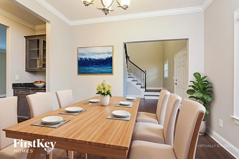 A dining room with a wooden table set for six.
