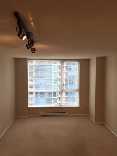 A room with a large window overlooking a building.