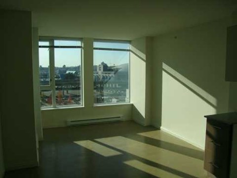A room with a large window overlooking a cityscape.