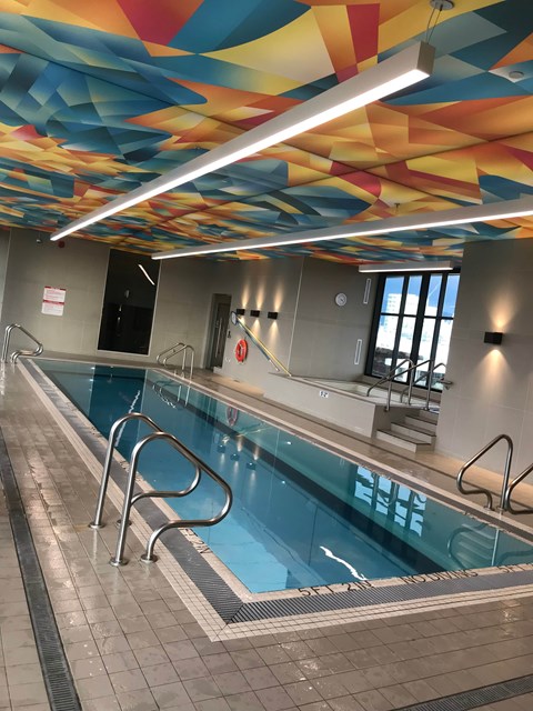 A swimming pool with a colorful ceiling.