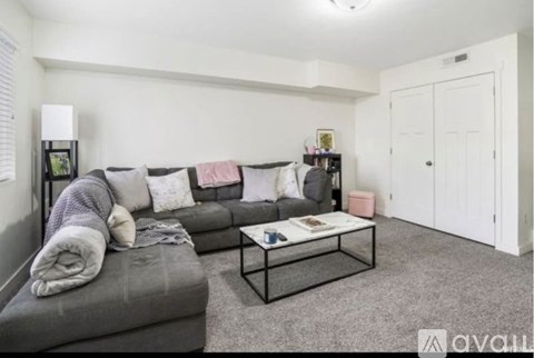 A living room with a grey couch and a coffee table.