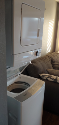A washing machine is placed in a living room.