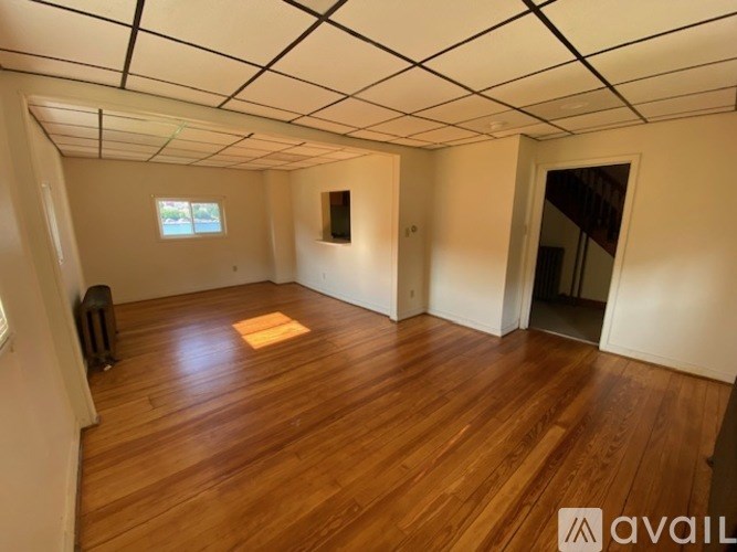 A room with wooden floors and a window.