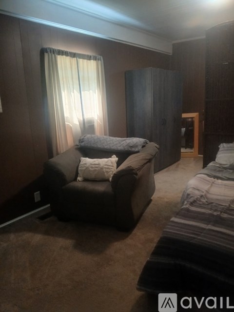 A living room with a couch and a chair.