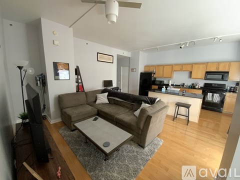 A living room with a grey couch and a television.