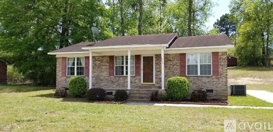 A brick house with a porch and a covered front door.