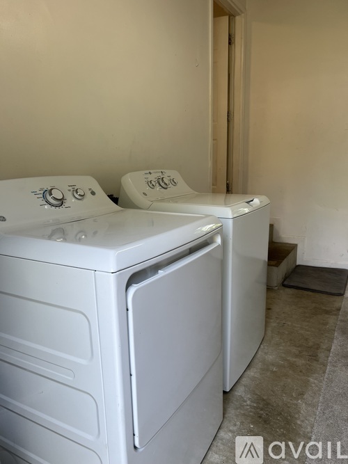 A white dryer and washer are sitting next to each other.