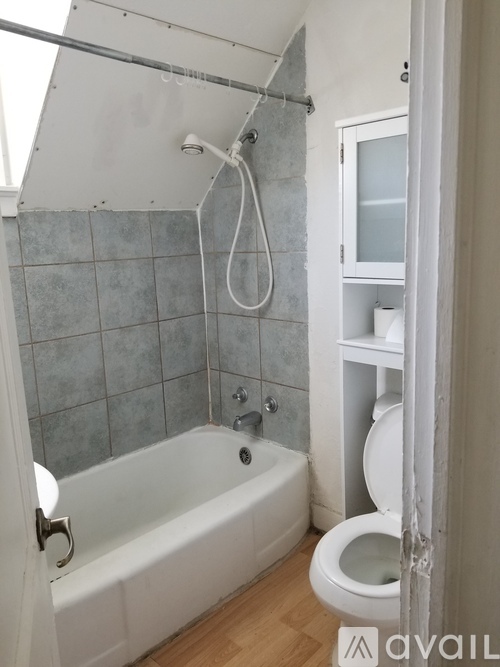 A bathroom with a white tub and toilet.