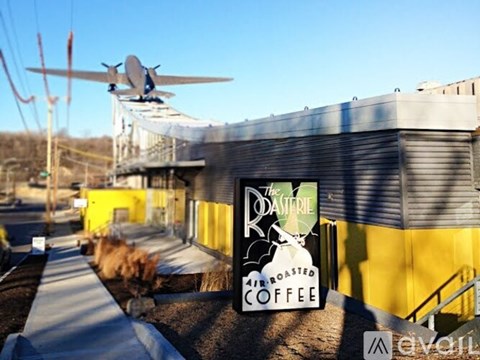A yellow building with a sign that says "The Rasperry Roasted Coffee".