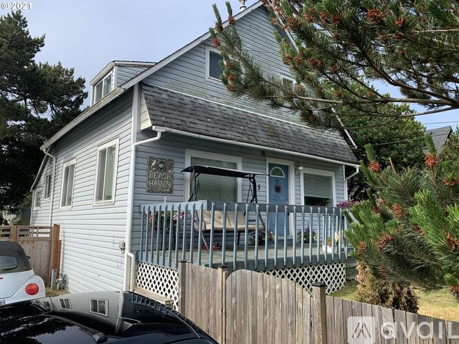 A house with a car parked in front of it.