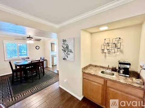 A kitchen with a dining table and chairs is available for rent.