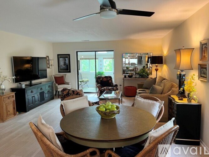 A living room with a dining table and chairs.