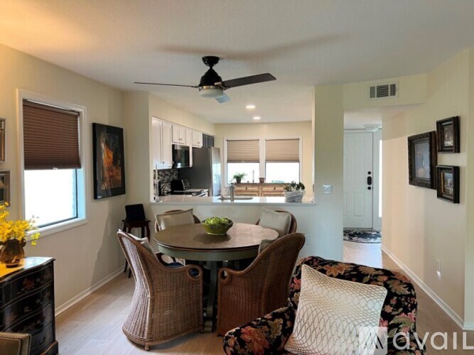 A dining room with a round table and chairs.
