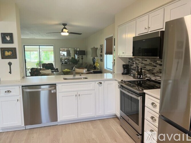 A kitchen with white cabinets and stainless steel appliances.