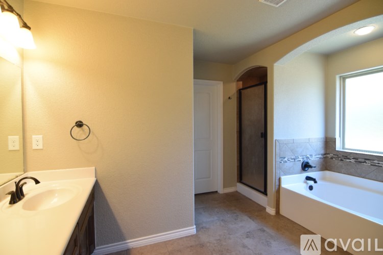 A bathroom with a white door and a shower curtain with circles on it.