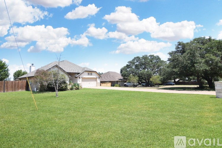A hallway with a tiled floor and a chandelier hanging from the ceiling.