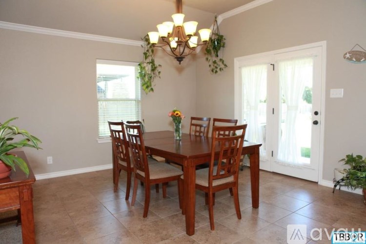 A dining room with a table and chairs.