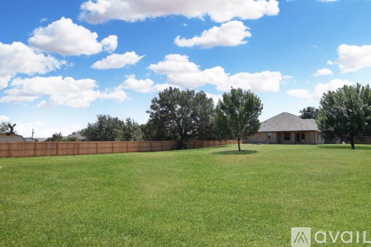 A bedroom with a bed, two lamps, and a ceiling fan.