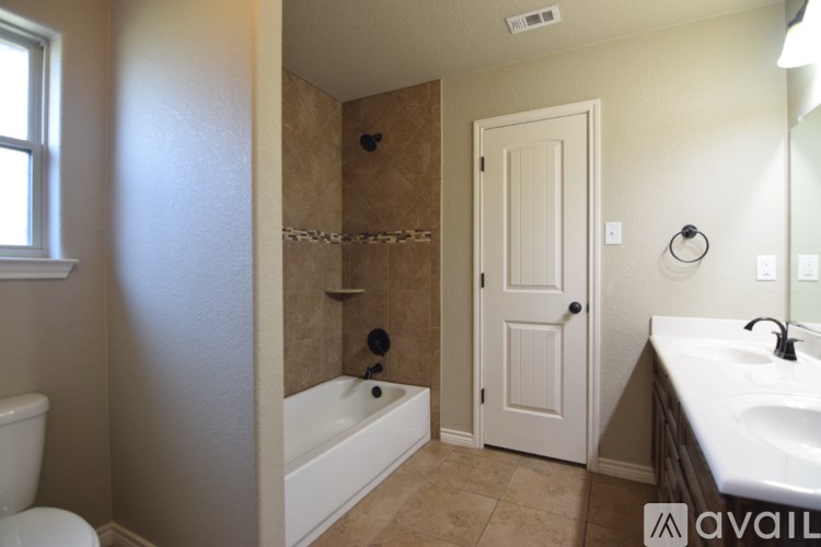 A bedroom with a bed, a ceiling fan, and a television.