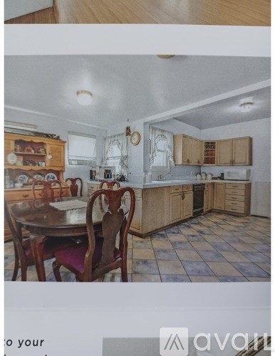 A kitchen with wooden cabinets and a checkered floor.