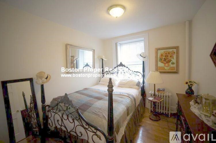 A bedroom with a bed, a dresser, and a mirror.