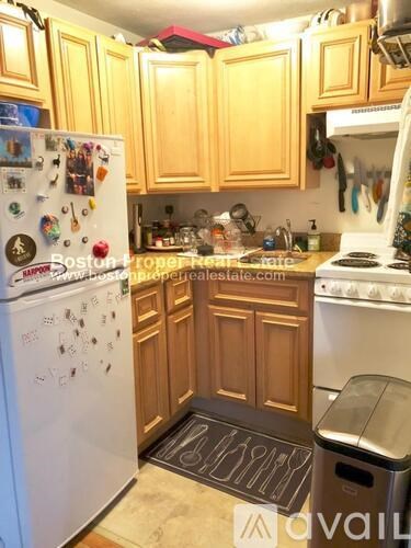 A kitchen with wooden cabinets and a white fridge.