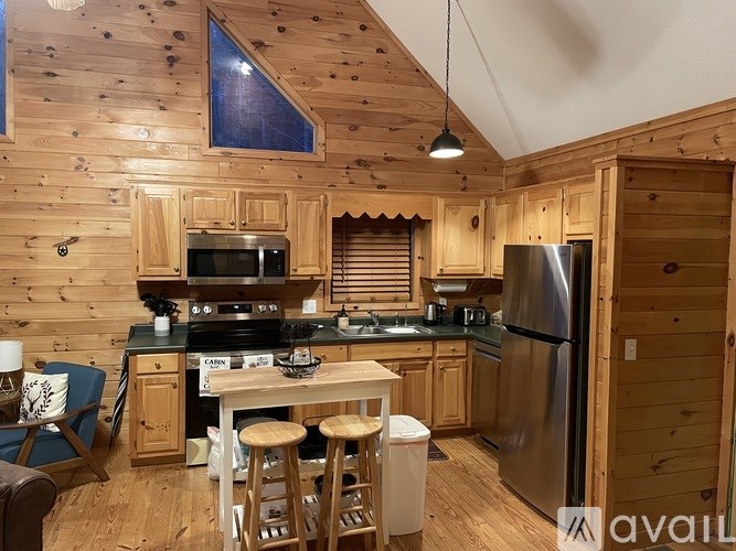 A kitchen with wooden cabinets and a stainless steel refrigerator.