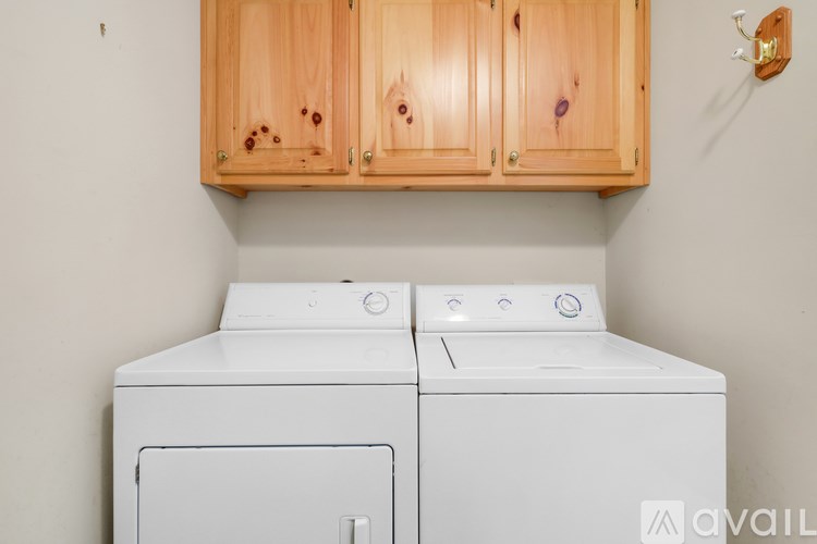 A white washing machine and dryer in a laundry room.
