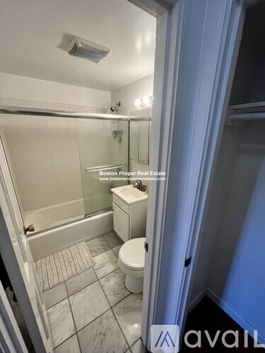 A bathroom with a toilet and a walk-in shower.