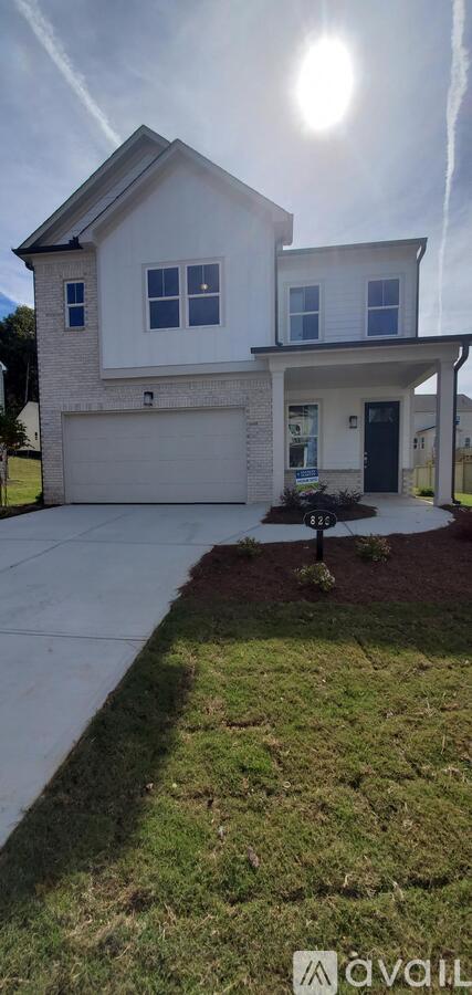 A house with a white exterior and a black door is shown.