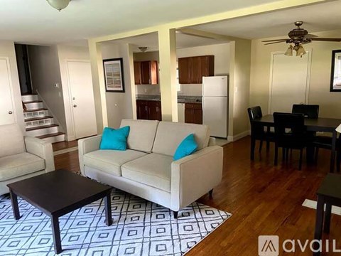 A living room with a white couch and a black coffee table.
