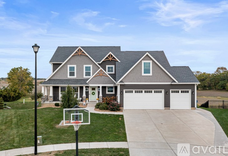 A house with a basketball hoop in front.