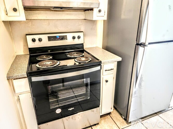A black oven with four burners is on a kitchen counter.