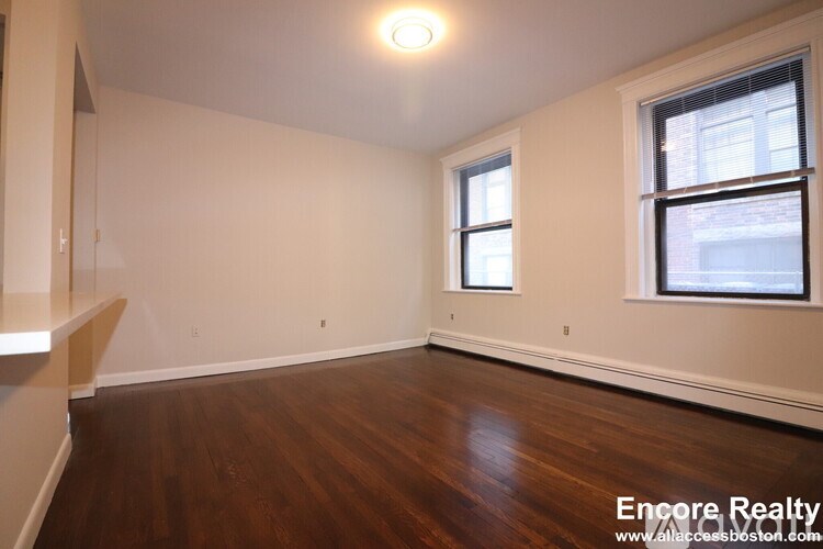 A room with wooden floors and a window.