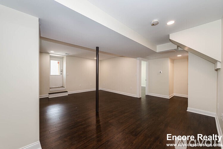 A room with wooden floors and white walls.