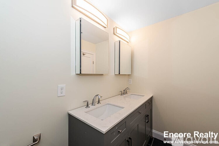 A bathroom with a sink and mirror.