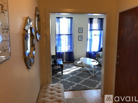 A room with a whiteboard on the wall and a mirror on the wall.