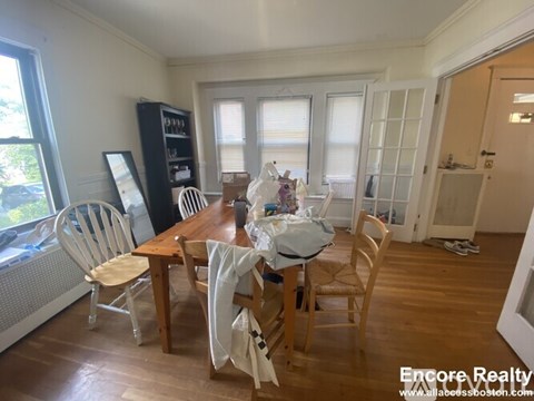 A dining room with a wooden table and chairs.