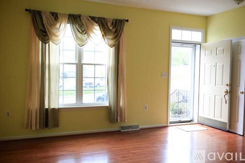 A room with a window and a door.