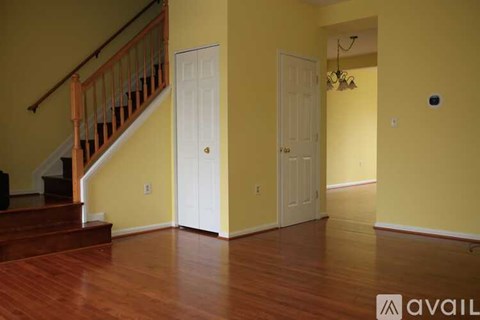A room with yellow walls and a wooden floor.