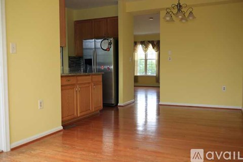 A kitchen with wooden cabinets and a refrigerator.