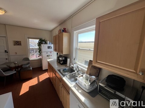 A kitchen with wooden cabinets and a white refrigerator.