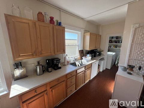 A kitchen with wooden cabinets and a white countertop.