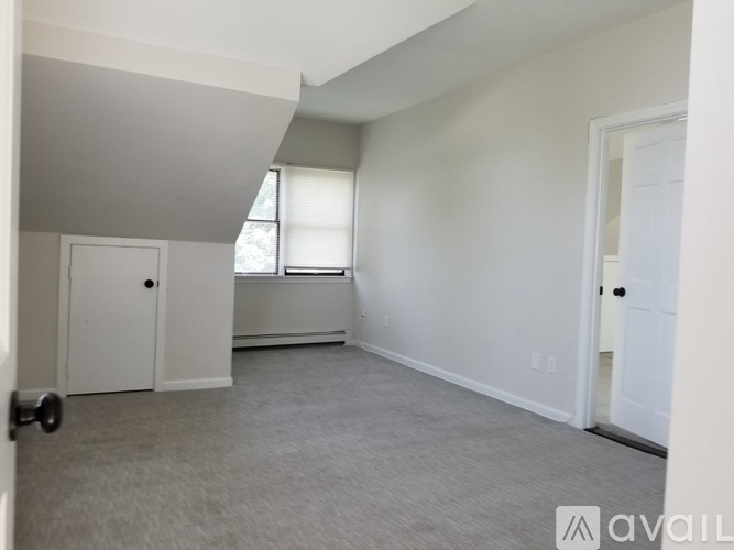 A room with a door, a window, and a wall with a logo on it.