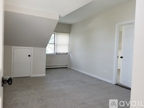 A room with a door, a window, and a wall with a logo on it.