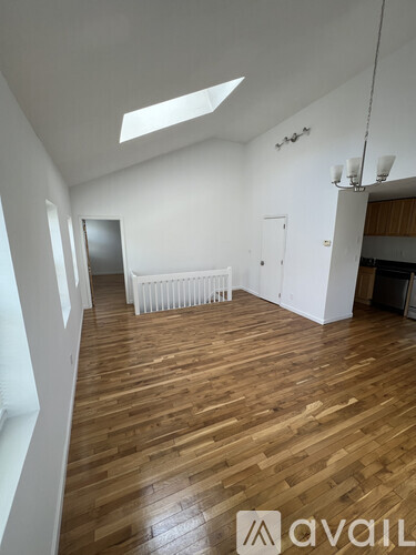 A room with wooden floors and white walls.