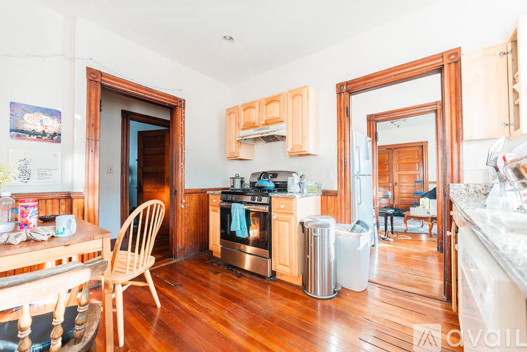 A kitchen with wooden floors and a wooden chair.