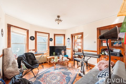 A living room with a grey couch and a black chair.